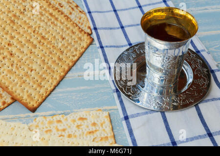 Silver wine cup with matzah, Jewish symbols for the Passover Pesach holiday. Passover concept. Stock Photo