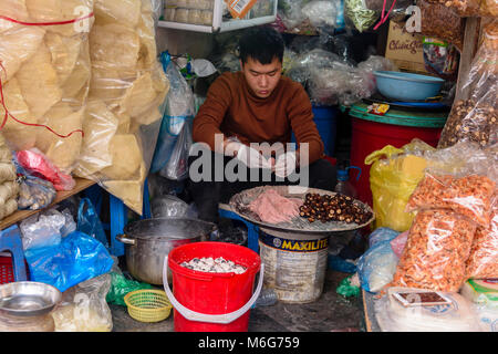 A man prepares street food at his shop in Hanoi, Vietnam Stock Photo