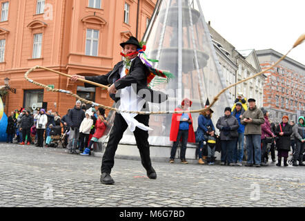 Ljubljana, Slovenia - February 10, 2018 - Traditional carnival on shrove Saturday and person with big rope-made whip, which creates loud bang, Ljublja Stock Photo