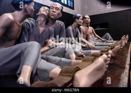 Mannequins used to demonstrate the conditions within Hỏa Lò Prison, including showing the use of metal shackles in Hanoi, Vietnam Stock Photo