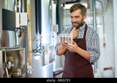 Smiling Technician Using Digital Tablet Stock Photo