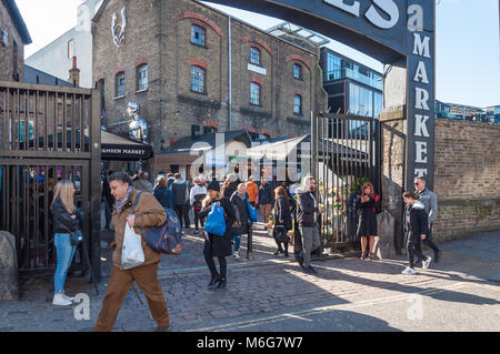 Saturday shoppers at and around the entrance to The Stables, Camden Market, London, England, UK. Stock Photo