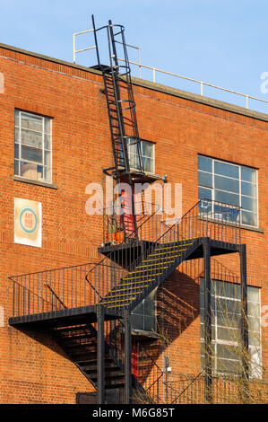 Fire escape staircase on side of industrial brick building, London, England, United Kingdom, UK Stock Photo