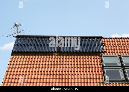 Solar glass tube hot water panel array on a roof Stock Photo