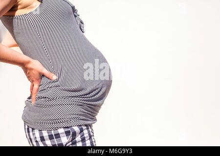 Profile of the pregnant woman wearing striped blouse on white background Stock Photo