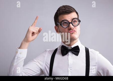 Contemplating Young Man Wearing Spectacles Having An Idea Stock Photo