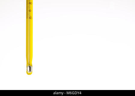 yellow mercury thermometer isolated on a white background. Scientific medical measuring device Stock Photo