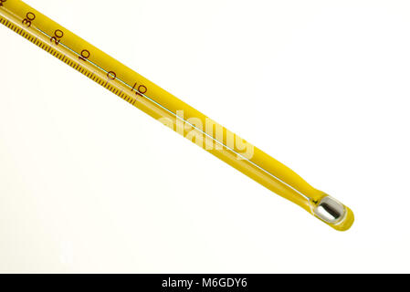 yellow mercury thermometer isolated on a white background. Scientific medical measuring device Stock Photo