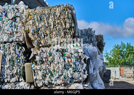 Pressed plastic bottles in briquettes for recycling at waste sorting station Stock Photo