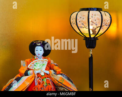 Japanese girls day empress doll. Girls day, called Hinamatsuri, doll display in Japan. Colorful Empress doll with lantern in front of golden backdrop. Stock Photo