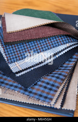 Close up view of fabrics samples on table in tailor workshop Stock Photo