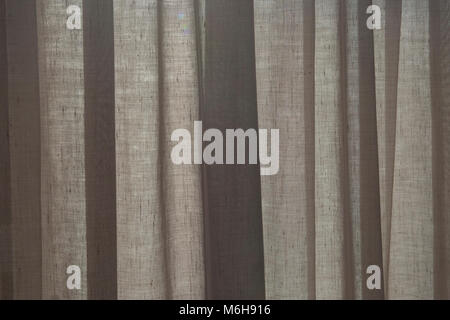 Sunlight behind the blinds and the curtain by the window Stock Photo
