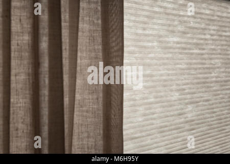 Sunlight behind the blinds and the curtain by the window Stock Photo