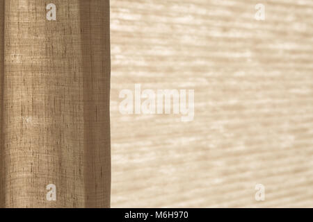 Sunlight behind the blinds and the curtain by the window Stock Photo