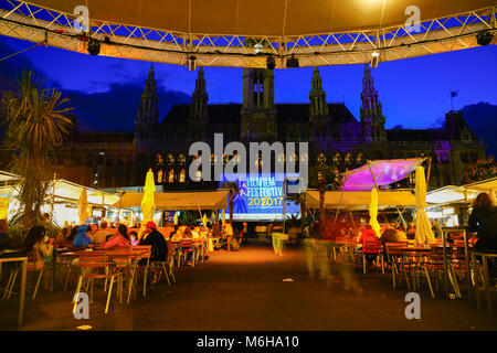 VIENNA,AUSTRIA - SEPTEMBER 4 2017; Film Festival night event with screening, food outlets and crowd of people in attendance and silhouette of city hal Stock Photo