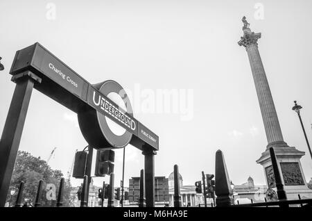 LONDON, UK - OCT. 15, 2017: Sign of Charing Cross Underground Station entrance and column of Admiral Nelson near Trafalgar Square in London England. Stock Photo