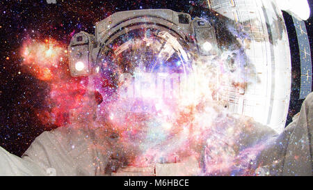 Astronaut in outer space. Science fiction art. Elements of this image furnished by NASA. Stock Photo