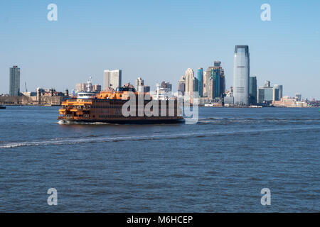 The Skyline of New Jersey and a Staten Island Ferry is seen from New York Harbor, NYC, USA Stock Photo