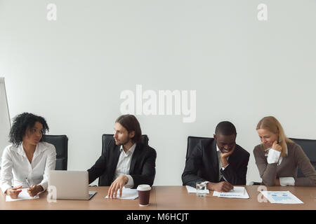 Diverse business people working talking at conference table, cor Stock Photo