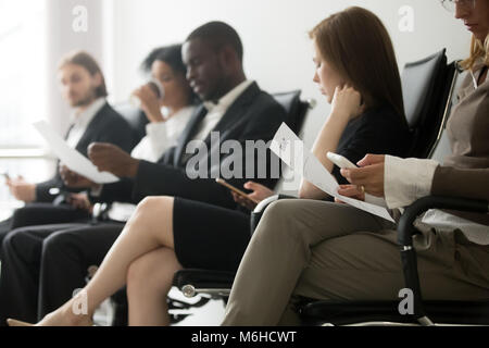 Multi-ethnic applicants sitting in queue waiting for job intervi Stock Photo