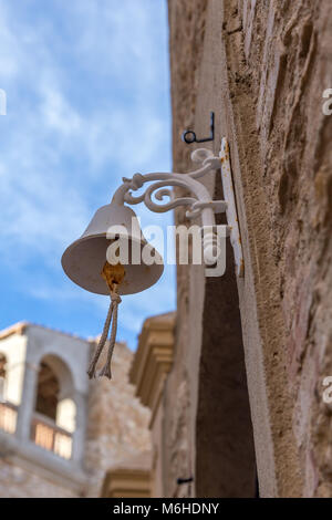 Nice white bell on the wall in a old Spanish village Begur Stock Photo