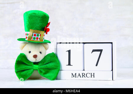 St.Patrick 's Day. A wooden calendar showing March 17. Green hat and bow Stock Photo