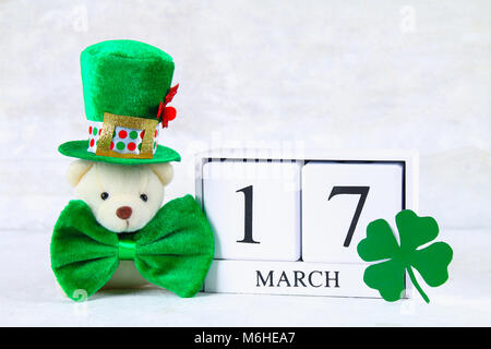 St.Patrick 's Day. A wooden calendar showing March 17. Green hat and bow Stock Photo