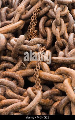 Close up of a pile of rusted chains of two sizes. Stock Photo