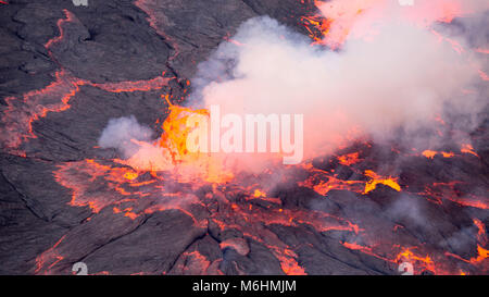 Lava bursts out of the worlds largest lava lake inside Nyiragongo in the Democratic Republic of Congo.  Taken 500 metres inside the active volcano. Stock Photo