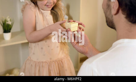 Loving father presenting surprised daughter with nice gift, happy childhood Stock Photo