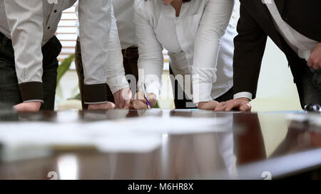 Female worker explaining data in monthly report, teamwork at business meeting Stock Photo