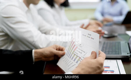 Man analyzing report document, political experts team working on election plan Stock Photo