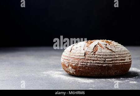 Bread rye, whole grain on a grey slate background. Copy space. Stock Photo