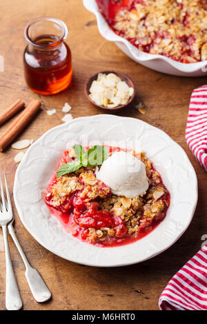 Crumble with berries and fruits with vanilla ice cream. Stock Photo