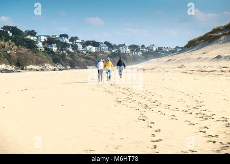People walking along Crantock Beach in Newquay Cornwall. Stock Photo