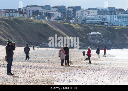 People walking on Fistral Beach on a cold day Newquay Cornwall. Stock Photo