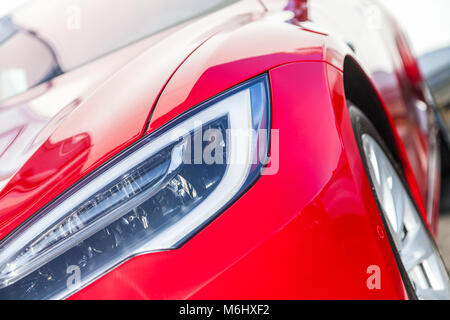 shiny headlights on a red sports car Stock Photo