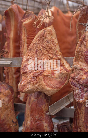 Hanging smoked pork bacon, shallow focus Stock Photo