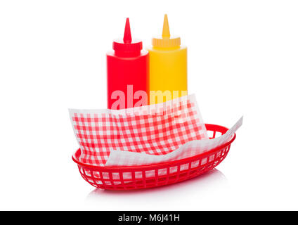 Hot dog fast food basket with ketchup and mustard and red paper on white background Stock Photo