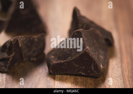 dark chocolate chunks on wood table Stock Photo