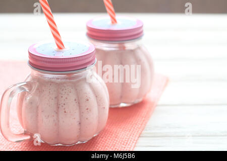 Healthy strawberry smoothie in a mason a jar mug