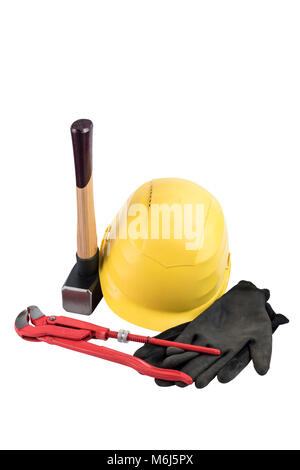 Yellow safety helmet with a sledgehammer with wooden handle, working gloves and adjustable plumbers wrench isolated on a white background, surface. Pa Stock Photo