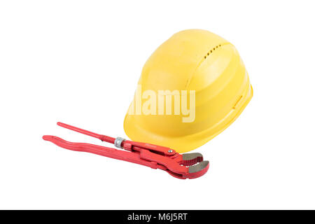 Used Yellow safety helmet with red adjustable pliers isolated on white background. Clipping path saved. Protection helmet, construction equipment. Yel Stock Photo