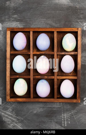 Multicolored eggs for Easter on black background. Top view. Food background Stock Photo