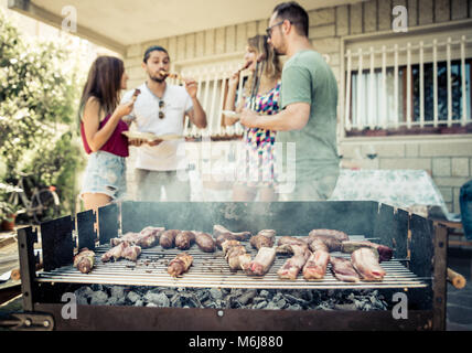 Group of friends making barbeque in the backyard. concept about good and positive mood with friends Stock Photo
