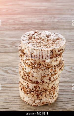 Stack of buckwheat crispbreads on light wooden table Stock Photo