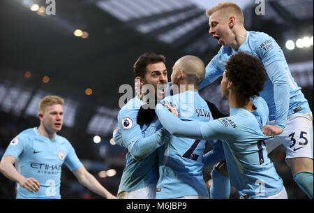 Manchester City's Bernardo Silva (centre) celebrates scoring the games first goal for his team with David Silva, Alexander Zinchenko, and Leroy Sane during the Premier League match at the Etihad Stadium, Manchester.