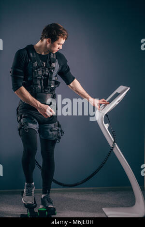 man training on stepper with electric muscle stimulation Stock Photo