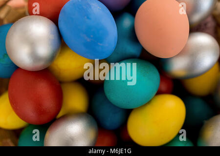 Background image close up of colorful Easter eggs in matte and silver paint, copy space Stock Photo