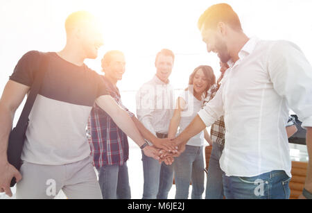 .friendly team of designers clasped their hands together Stock Photo